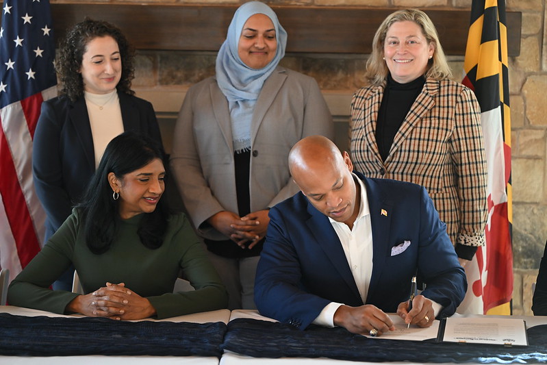 Governor Moore signs  Executive Order 01.01.2025.08 with Lt. Governor Aruna Miller, Deputy Chief Performance Officer Sophie Bergmann, Chief Perfomrance Officer Asma Mirza, and Director of Government Modernization Elisabeth Sachs